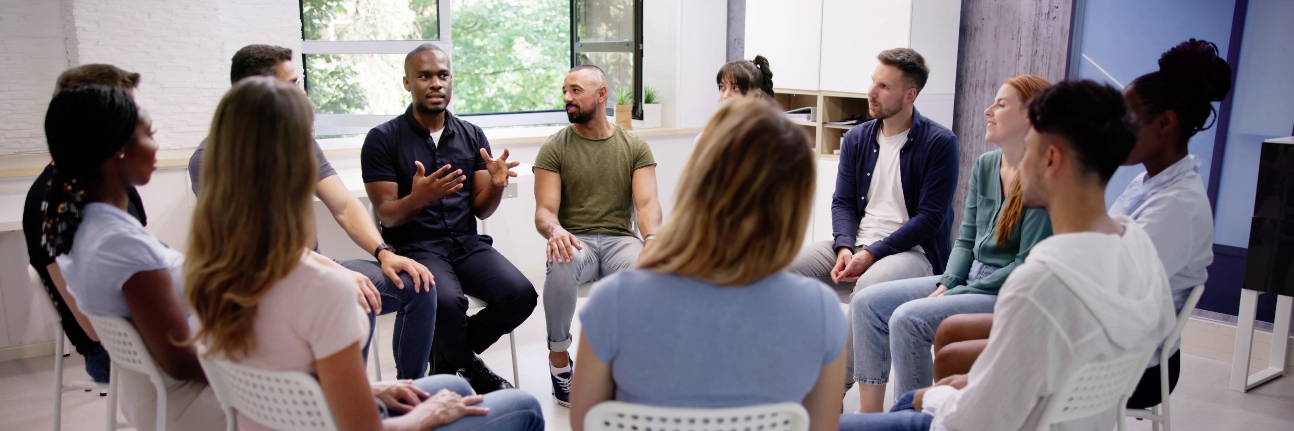 Group sitting in circle having a discussion